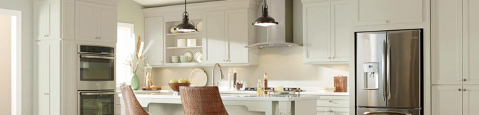 Off white shaker cabinets in a casual kitchen with double oven wall cabinet, working island, open shelves, and refrigerator cutout 