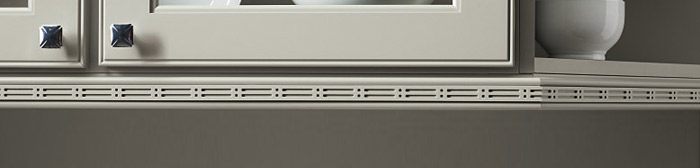 close up of decorative insert moulding on light gray cabinets